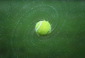 tennis ball with water on the field