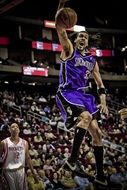 basketball player with ball in a high jump