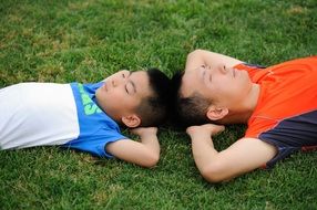 teenager relaxing on the field after football play