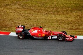 red racing car on the track in Barcelona