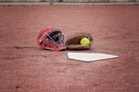 helmet and glove on a field in softball