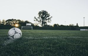 starting ball on a soccer field at sunset