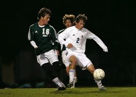 soccer players with the ball during the match