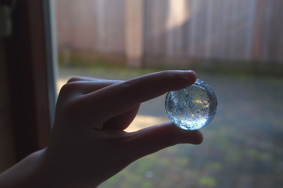glass ball in manâs hand