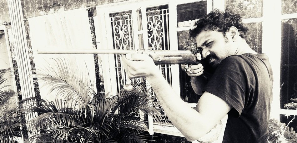 mature Man with Gun at building