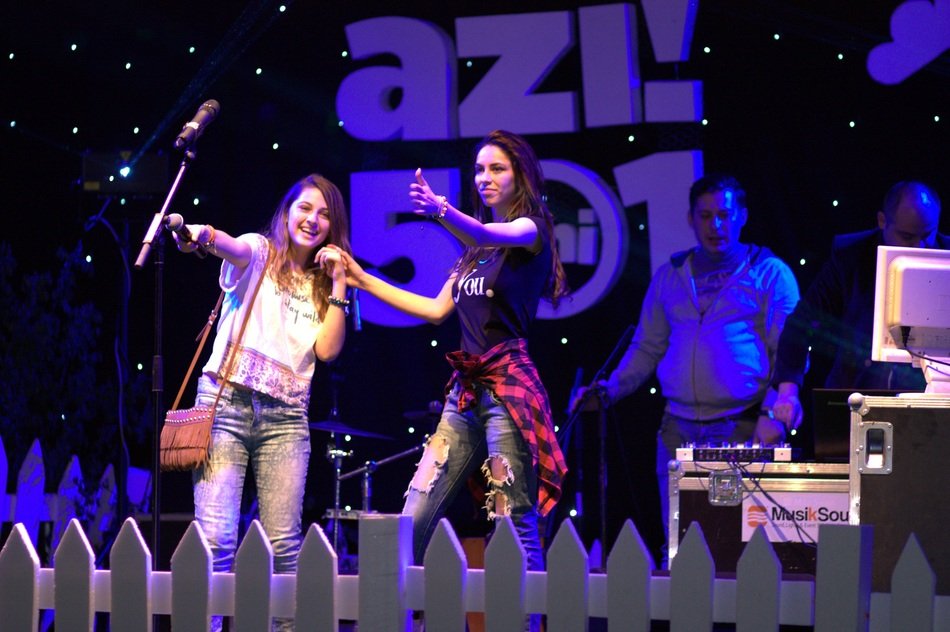 girls with a microphone at a concert
