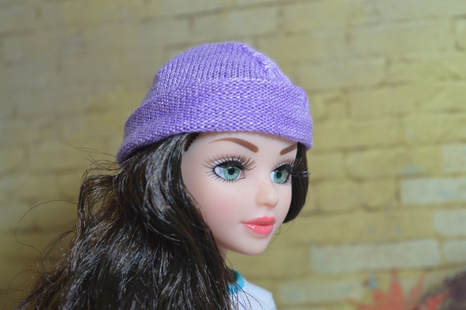 beautiful doll in a purple hat