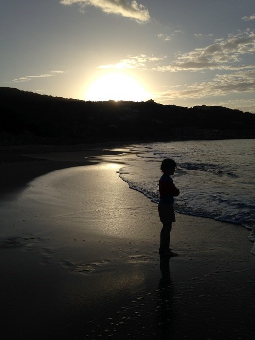 child at sunset by the sea