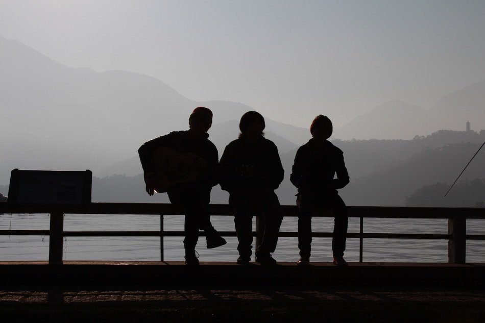 silhouette of people on the lake