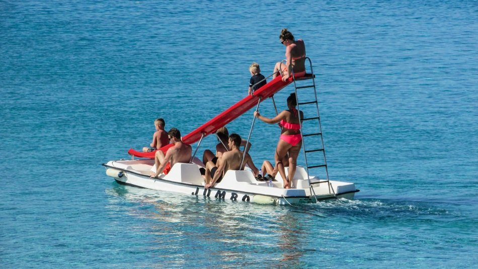 people on a catamaran with a slide in the sea on the coast of Protaras, Cyprus