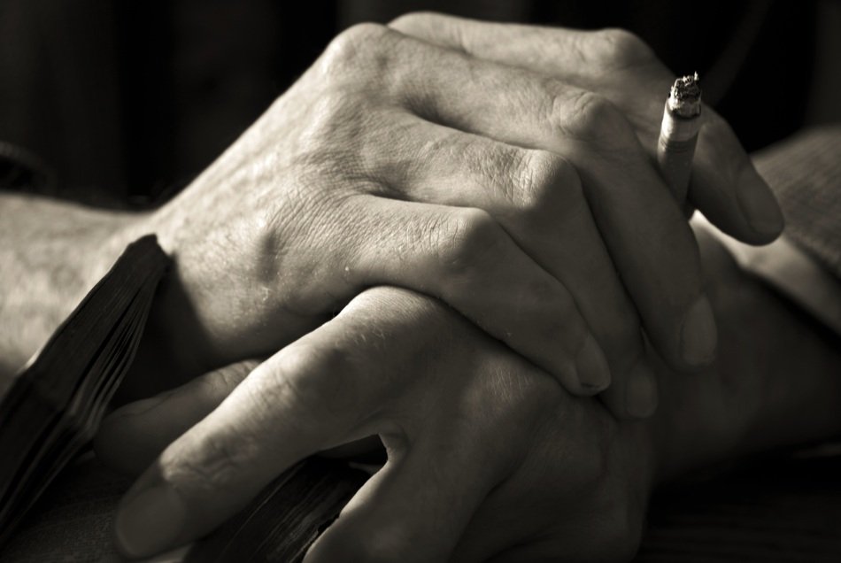 book and cigarette in hands closeup