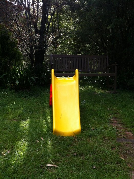 yellow plastic slide in the park