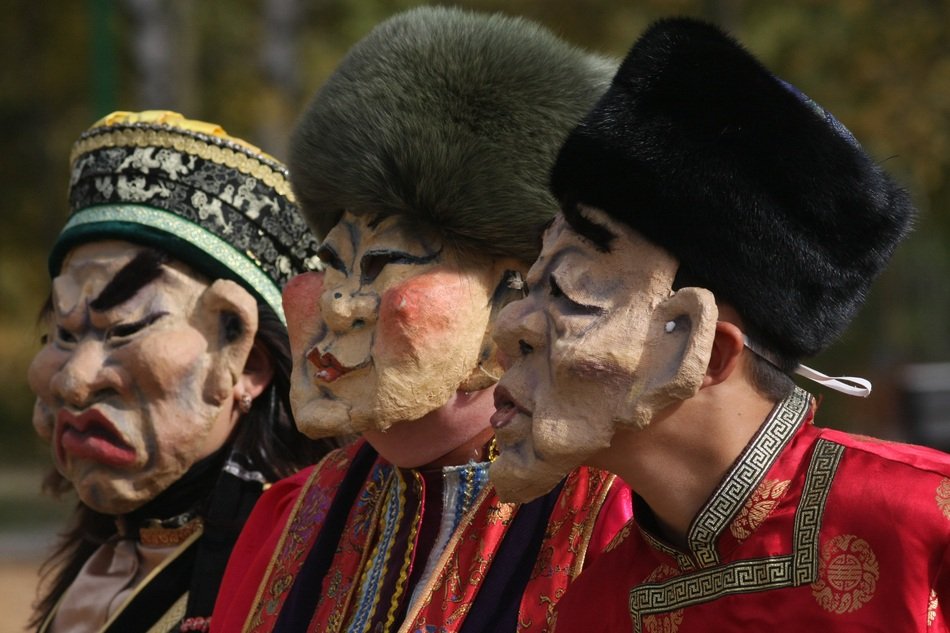 people with traditional masks and hats at the festival
