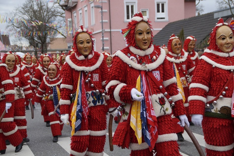 people in red suits at the festival in Plaetzlerzunft
