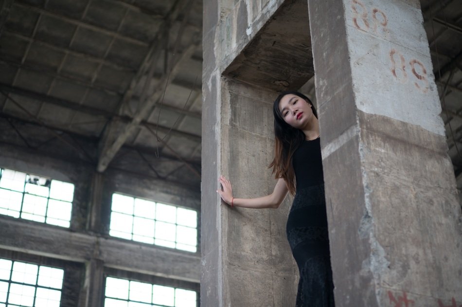 asian model between concrete columns