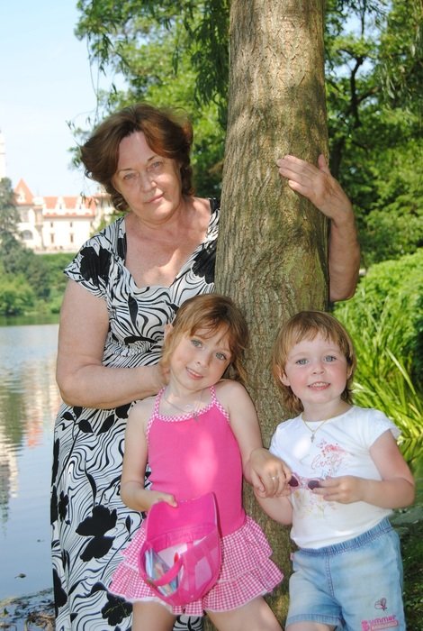 senior woman posing with two Kids in Park