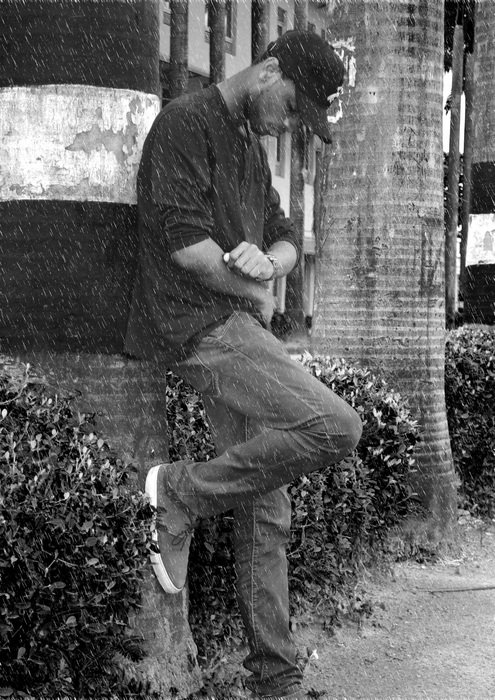 photo of an expecting young man near the wall