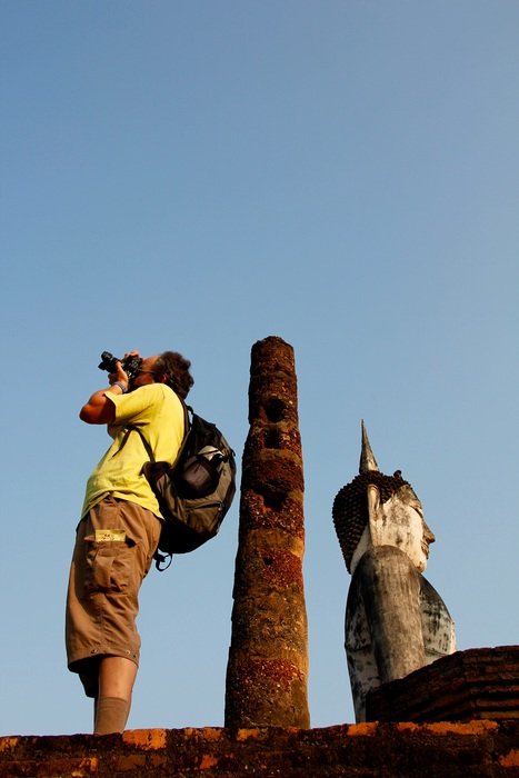 photographer on a roof on a sunny day