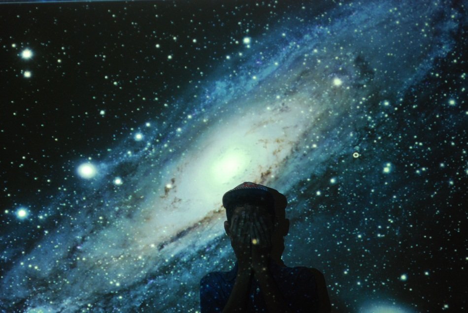 photo of a man on the background of the starry universe