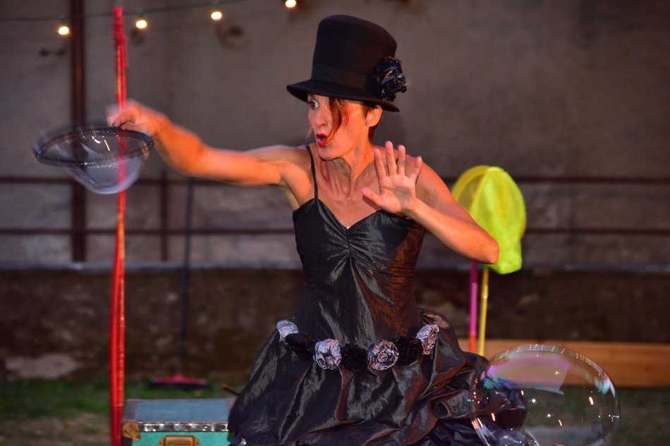 girl in a black dress on a soap bubble show