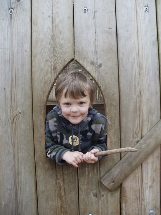 little boy at the window on a wooden door