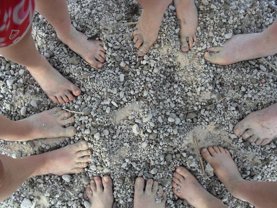 Feet on the stones of the beach