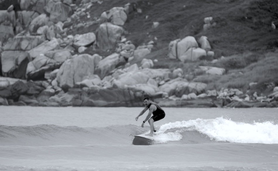 surfer on the wave near the shore
