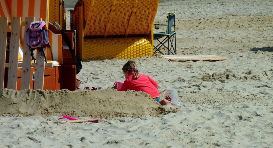 Child playing on the beach of North Sea