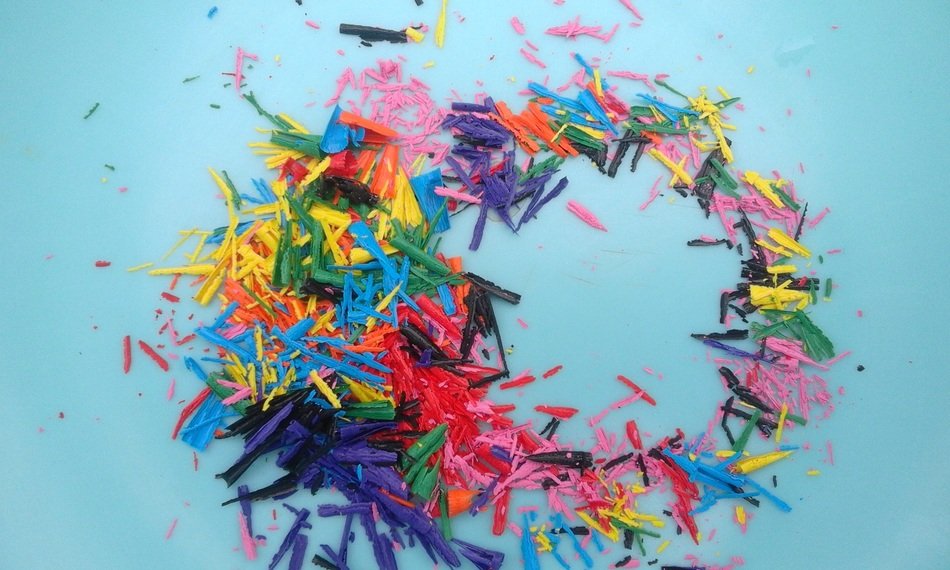 Crayons shavings at blue background
