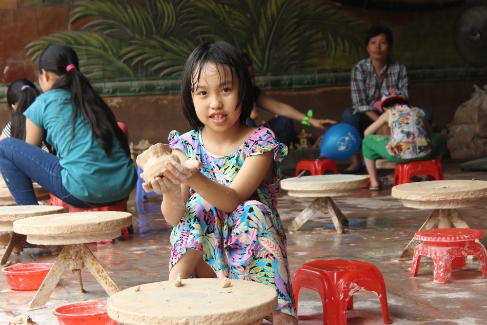 children make clay crafts in the village of Bat Trang