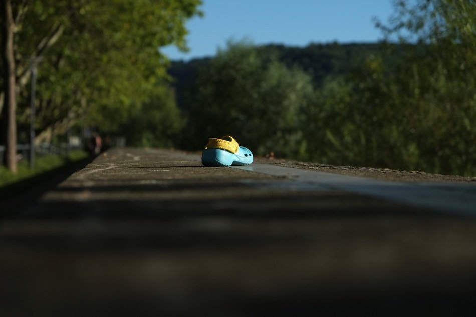 children's sandal lies on the road