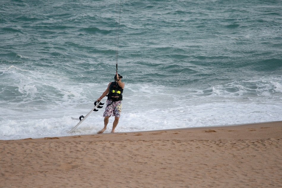 man windsurfer on the beach
