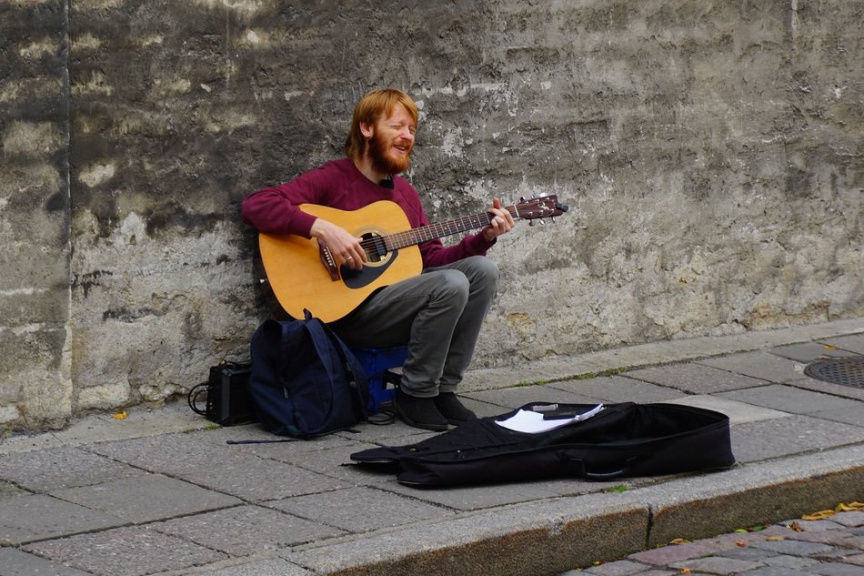 Musician with the guitar on the street