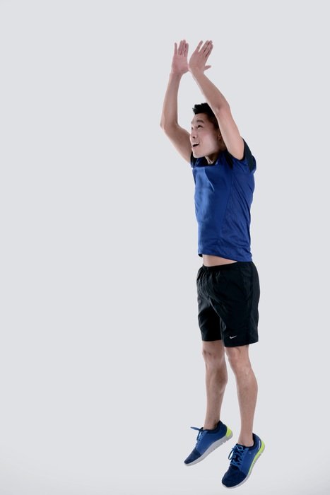 sportsman in a jump with his hands up