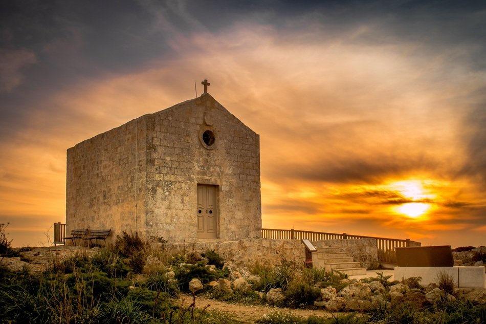 sunrise on the background of a stone building