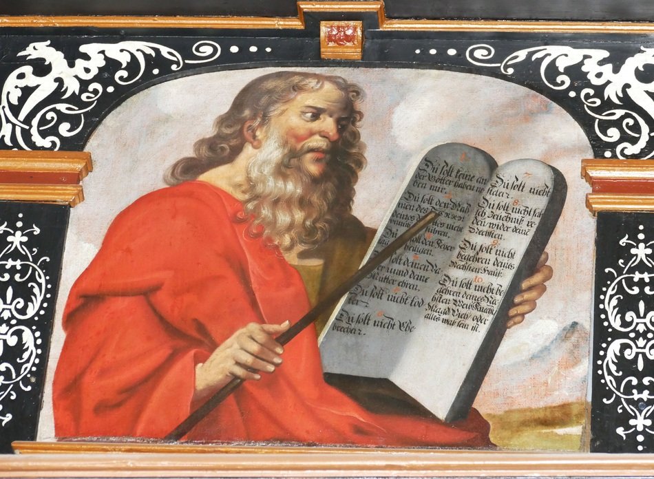 a man dressed in red with a stone