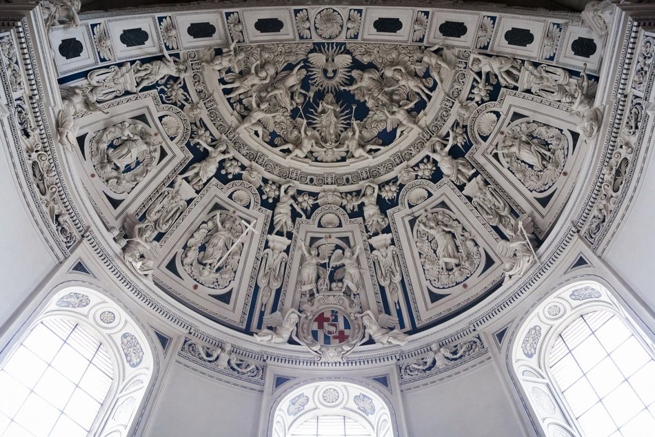 stone panel of figurines on the ceiling in the Church