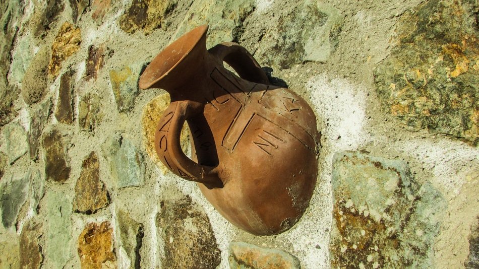 immured ceramic pitcher in the wall