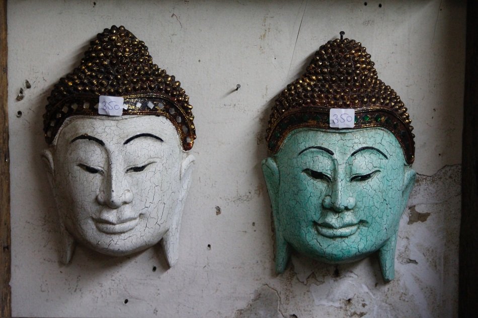 two decorations in the form of a buddha head