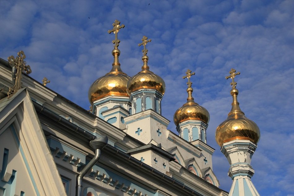 Golden domes with crosses on a church in Latvia