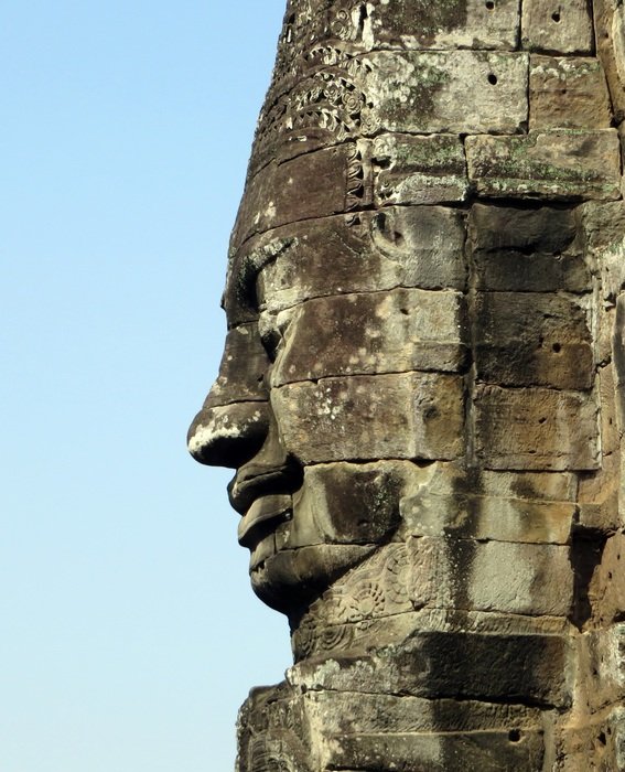 statue profile in angkor temple at blue sky background