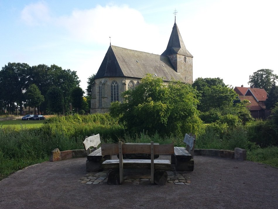 green trees near the old church