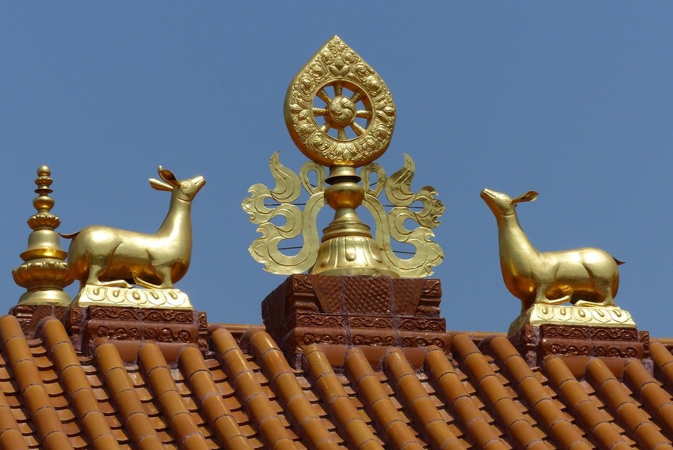 golden Dharmachakra on the roof of Temple
