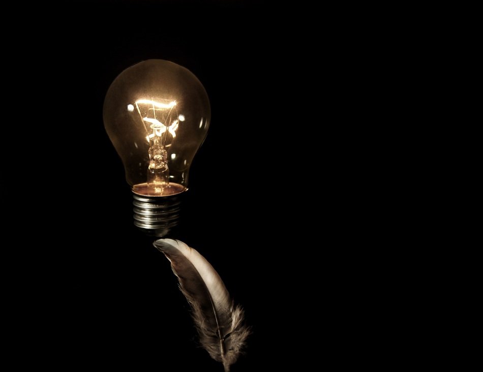 light bulb and pen on a black background