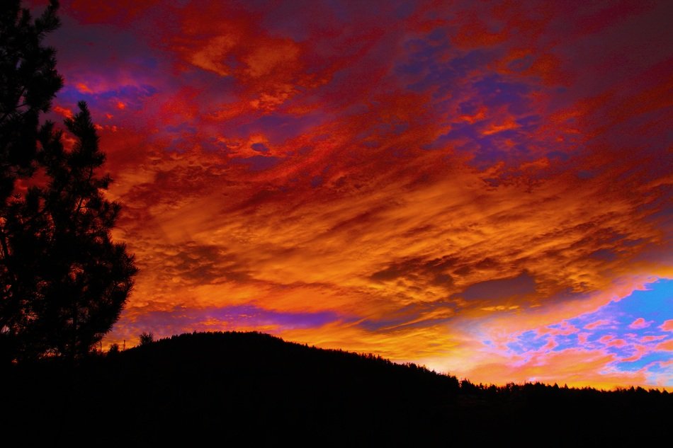 dark orange sky over the hill at dusk