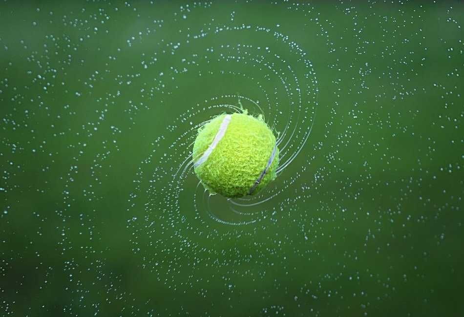 tennis ball with water on the field