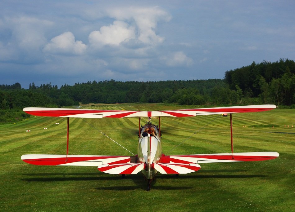 Beautiful colorful sport aircraft on the green meadow