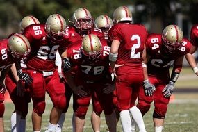 american football players in red uniform