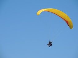 paragliding tandem in the blue sky