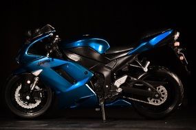blue motorcycle on black background